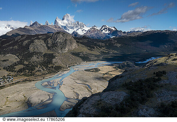 The green water of glacial melt winds its way down a valley in P