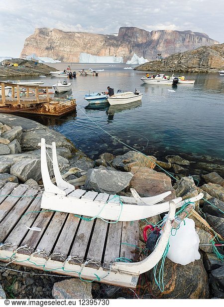 The harbour with typical fishing boats and dog sled. Small town Uummannaq in the north of west greenland. America  North America  Greenland  Denmark.
