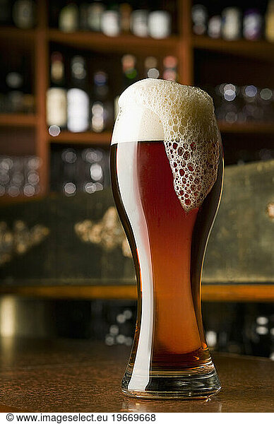 The head of a beer overflows at a pub in Montreal  Quebec  Canada.