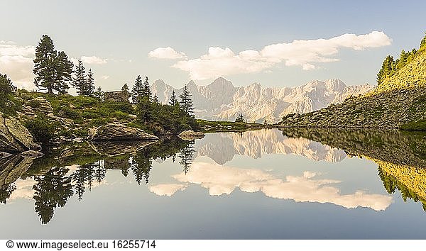 The Hoher Dachstein is reflected in the lake of mirrors at last daylight  Reiteralm  Styria  Austria  Europe