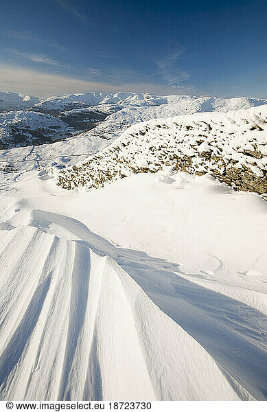 The Lake District mountains in winter snow from Red Screes  UK.