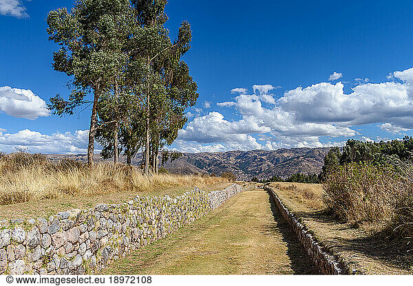 The landscape of the Urubamba province  view over the mountains  and a sunken path with stone walls  an example of the Inca building style.