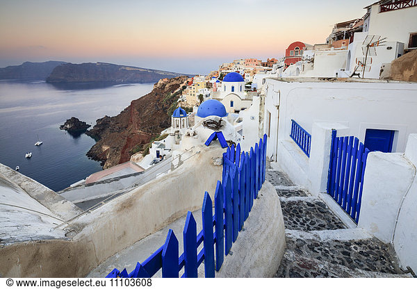 The last light of dusk over the Aegean Sea seen from the typical village of Oia  Santorini  Cyclades  Greek Islands  Greece  Europe