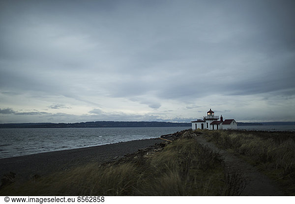 The lighthouse at dusk at Discovery Park in Seattle  WA.