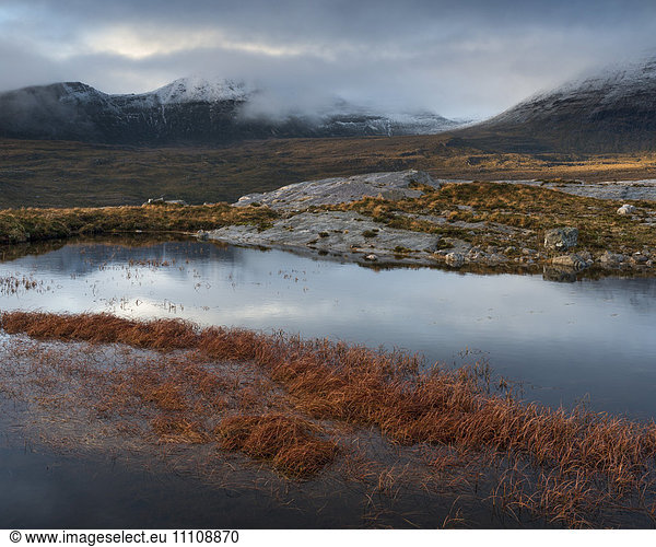 The mountain Quinag viewed across a lochan near Inchnadamph Sutherland Scotland United Kingom Europe