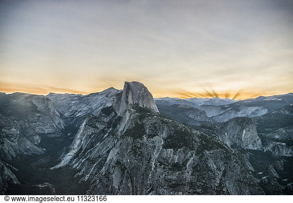 The mountain range in Yosemite valley at sunset. The Half Dome landmark