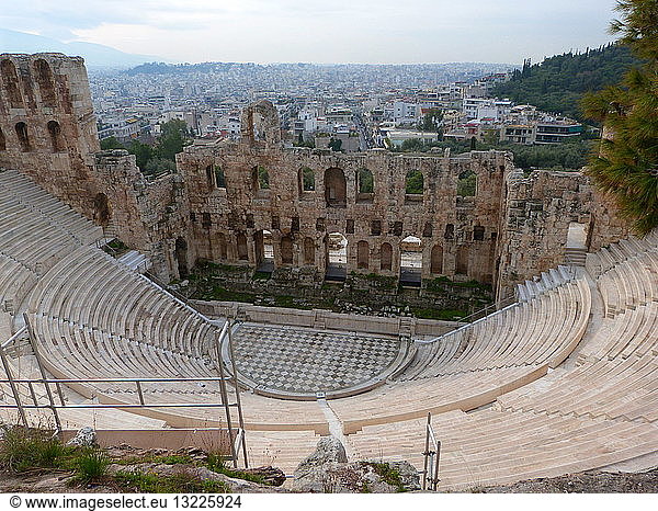 The Odeon of Herodes Atticus is a stone theatre structure located on the south slope of the Acropolis of Athens. It was built in 161 AD by the Athenian magnate Herodes Atticus in memory of his wife  Aspasia Annia Regilla. It was originally a steep-sloped amphitheatre with a three-story stone front wall and a wooden roof made of expensive  cedar of Lebanon timber. It was used as a venue for music concerts with a capacity of 5 000