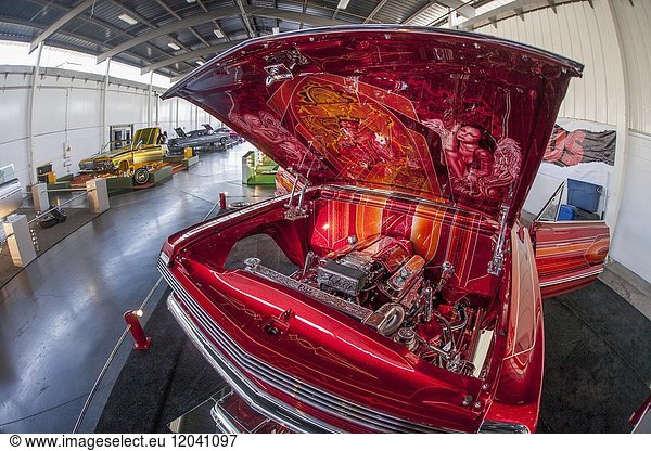 The ornately customized engine compartment of a 1963 Chevrolet Impala SS 'El Rey' is on display at a 'Low and Slow' car exhibit in Costa Mesa  CA.