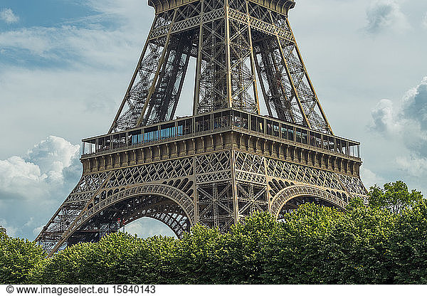 The part of Eiffel tower on the blue sky with clouds in Paris  France.