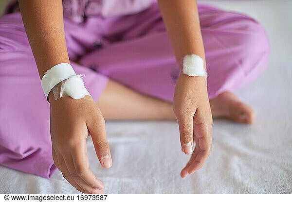 The patient showed healing bandages on both wrists