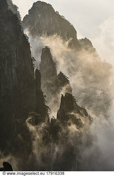 The steep jagged granite peaks of the Huangshan Mountains  the Yellow Mountains  mist and cloud in the valleys among the peaks.