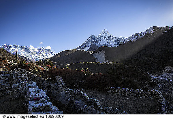 The summit of Ama Dablam looms over shadows of Nepal's Khumbu Valley.
