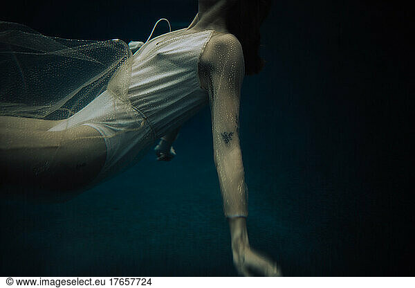 The torso of feminine woman floating in open water