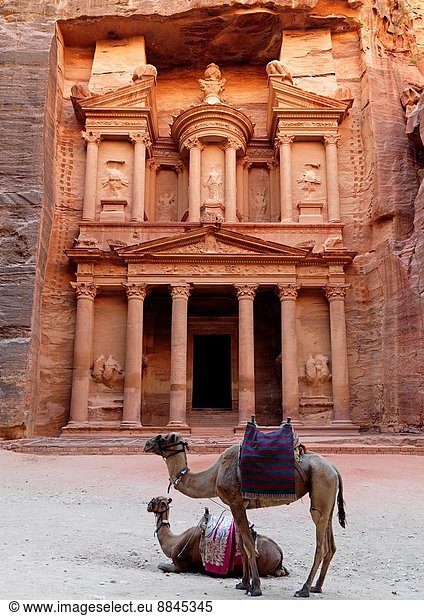 the Treasury (el Khazneh) is carved out from the sandstone cliff wall  it was probably a temple tomb  Petra is in a valley and was founded by the Nabatean civilization  who carved buildings out of the red rock face.