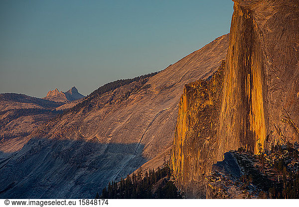 The vertical face of Half Dome at sunset in Yosemite with Echo Peaks