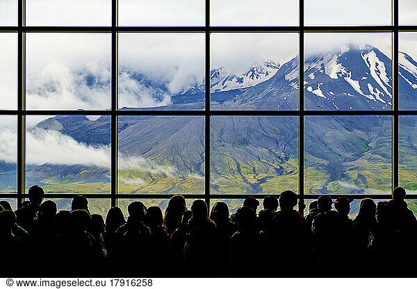 The view through a window with a grid pattern  a row of people viewing the volcano at Mount St. Helens National Volcanic Monument.
