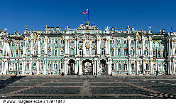 The Winter Palace  a Baroque style palace and official residence of the House of Romanov from 1732 to 1917  the facade with a flag flying.