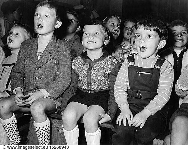 theatre / theater  audience  group of children following a performance of a Punch and Judy show  1950s