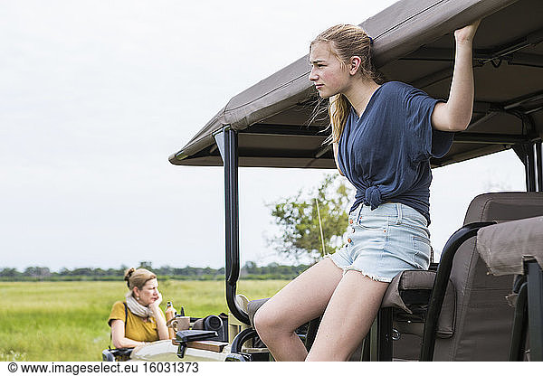 Thirteen year old girl on safari vehicle  Botswana