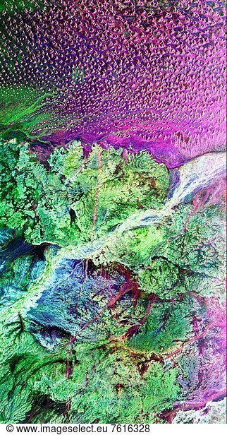 This is a radar image of the region around the site of the lost city of Ubar in southern Oman  on the Arabian Peninsula. The ancient city was discovered in 1992 with the aid of remote sensing data. Archeologists believe Ubar existed from about 2800 B.C. to about 300 A.D. and was a remote desert outpost where caravans were assembled for the transport of frankincense across the desert.This image was acquired on orbit 65 of space shuttle Endeavour on April 13  1994 by the Spaceborne Imaging Radar C/X_Band Synthetic Aperture Radar SIR_C/X_SAR. The SIR_C image shown is centered at 18.4 degrees north latitude and 53.6 degrees east longitude. The image covers an area about 50 by 100 kilometers 31 miles by 62 miles. The image is constructed from three of the available SIR_C channels and displays L_ band  HH horizontal transmit and receive data as red  C_ band HH as blue  and L_band HV horizontal transmit vertical receive as green. The prominent magenta colored area is a region of large sand dunes  which are bright reflectors at both L_ and C_band. The prominent green areas L_HV are rough limestone rocks  which form a rocky desert floor. A major wadi  or dry stream bed  runs across the middle of the image and is shown largely in white due to strong radar scattering in all channels displayed L and C HH  L_HV.The actual site of the fortress of the lost city of Ubar  currently under excavation  is near the Wadi close to the center of the image. The fortress is too small to be detected in this image. However  tracks leading to the site  and surrounding tracks  appear as prominent  but diffuse  reddish streaks. These tracks have been used in modern times  but field investigations show many of these tracks were in use in ancient times as well. Mapping of these tracks on regional remote sensing images was a key to recognizing the site as Ubar in 1992. This image  and ongoing field investigations  will help shed light on a little known early civilization.Spaceborne Imaging Radar_C and X_Band Synthetic Aperture Radar SIR_C/X_SAR is part of NASA´s Mission to Planet Earth. The radars illuminate Earth with microwaves allowing detailed observations at any time  regardless of weather or sunlight conditions. SIR_C/X_SAR uses three microwave wavelengths: L_band 24 cm  C_band 6 cm and X_band 3 cm. The multi_frequency data will be used by the international scientific community to better understand the global environment and how it is changing. The SIR_C/X_SAR data  complemented by aircraft and ground studies  will give scientists clearer insights into those environmental changes which are caused by nature and those changes which are induced by human activity.SIR_C was developed by NASA´s Jet Propulsion Laboratory. X_SAR was developed by the Dornier and Alenia Spazio companies for the German space agency  Deutsche Agentur fuer Raumfahrtange_ legenheiten DARA  and the Italian space agency  Agenzia Spaziale Italiana ASI  with the Deutsche Forschungsanstalt fuer Luft und Raumfahrt e.v.DLR  the major partner in science  operations  and data processing of X_SAR.