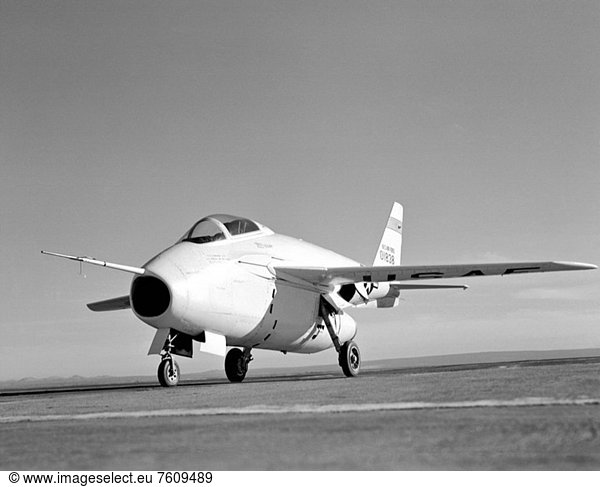 This NACA High_Speed Flight Research Station photograph of the X_5 was taken at the South Base of Edwards Air Force Base. The photograph portrays a left wing side view of the aircraft and also shows the pitot_static probe  used to measure airspeed  Mach number  and altitude  mounted on a noseboom protruding from the top of the aircraft´s nose engine inlet. Also attached to the pitot_static probe portion of the noseboom are flow direction vanes for sensing the aircraft’s angles_of_attack and sideslip in flight.