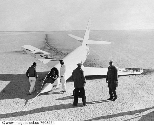 This 1952 photograph shows the X_2 2 with a collapsed nose landing gear after landing on the first glide flight at Edwards Air Force Base. The aircraft pitched at landing  slid along its main skid and contacted the ground with the right wingtip bumper skid causing it to break off. The nose wheel had collapsed upon contacting the ground.