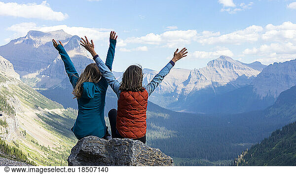 Tho girls loving the magical summer day view in Glacier National Park