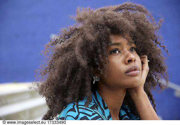Thoughtful Afro woman with hand on chin