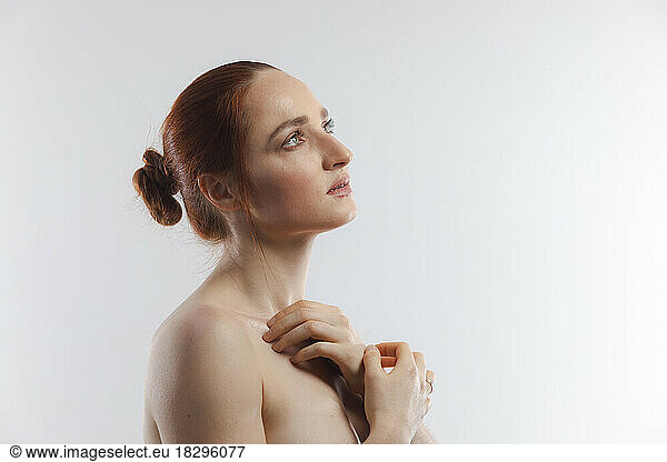 Thoughtful beautiful woman against white background