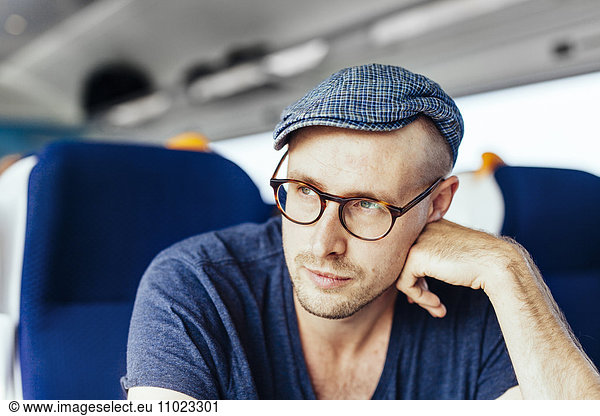 Thoughtful businessman travelling in train