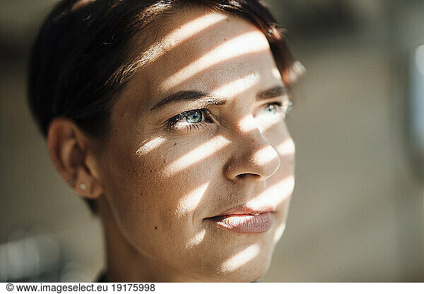 Thoughtful businesswoman with sunlight on face