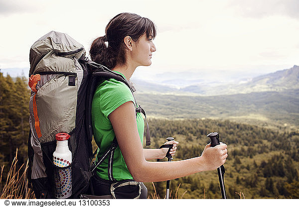 Thoughtful female hiker carrying backpack
