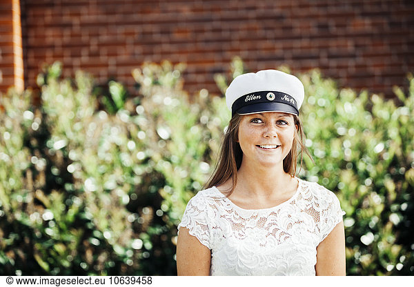 Thoughtful female student smiling at graduation party