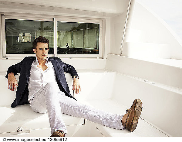 Thoughtful handsome man sitting in boat
