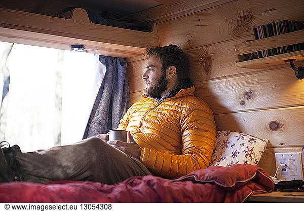 Thoughtful man relaxing in camper van