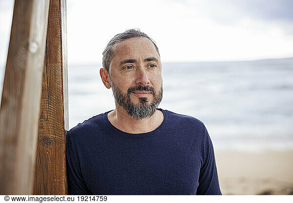 Thoughtful man with beard at beach