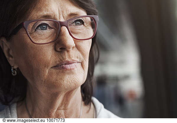Thoughtful senior businesswoman looking away in office
