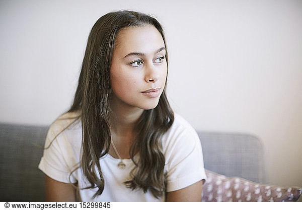 Thoughtful teenage girl sitting at wellness center