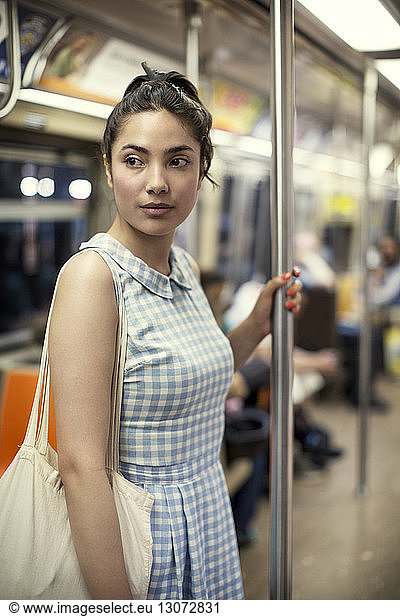 Thoughtful woman traveling in subway train