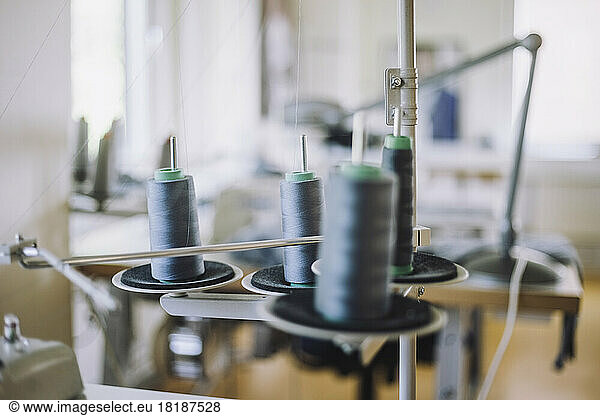 Thread spools on sewing machine at workshop