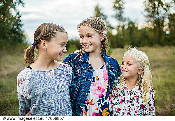 Three beautiful girls smiling  laughing  smiling outdoors.