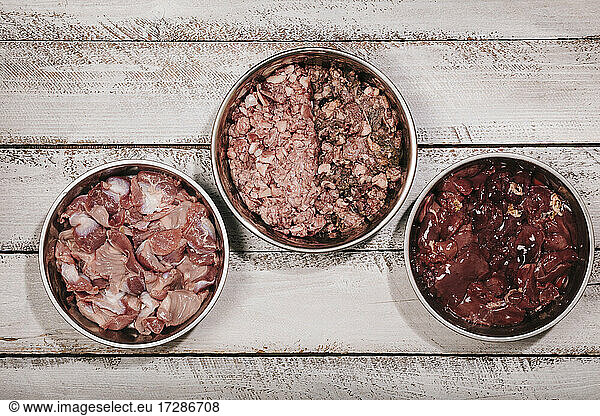 Three bowls of biologically appropriate raw food (BARF) for dog diet