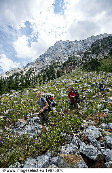 Three boys backpack below Sacajawea Peak in the Eagle Cap wilderness in northeastern Oregon on Day 5 of their trek.
