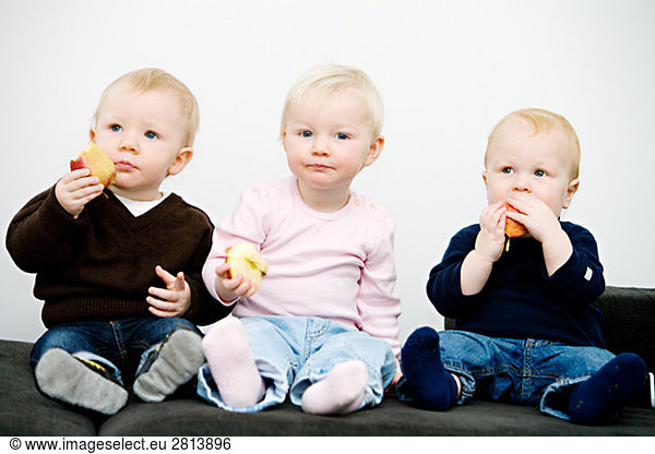 Three children holding apples Sweden.