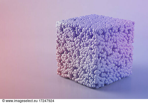 Three dimensional render of cube made of purple spheres