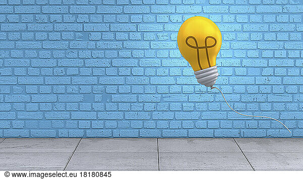 Three dimensional render of light bulb floating against blue brick wall