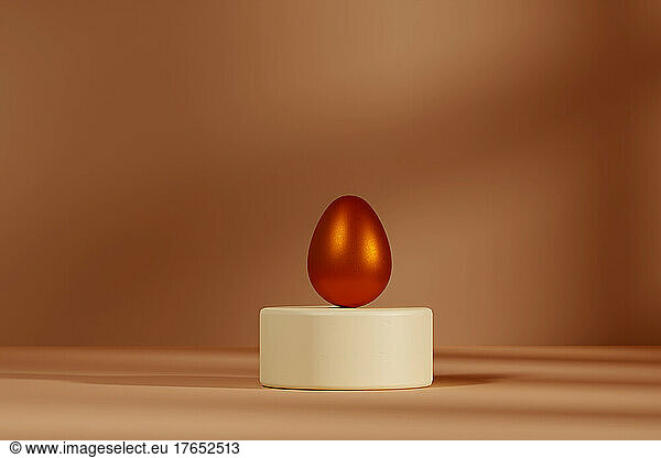Three dimensional render of metallic egg on pedestal