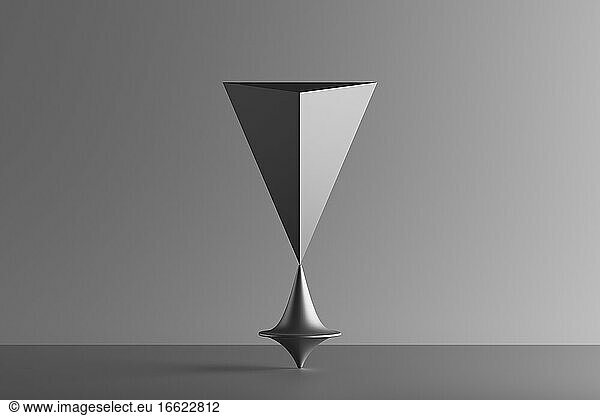 Three dimensional render of metallic top spinning under geometric pyramid standing upside down