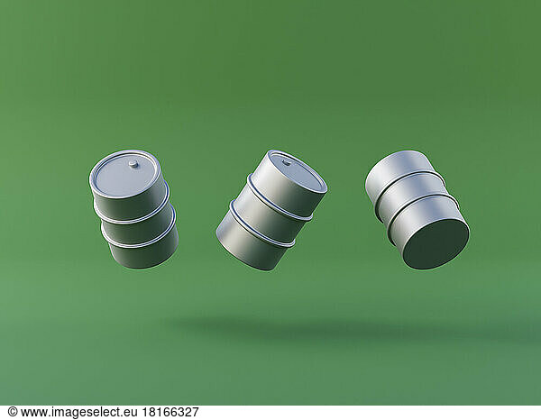 Three dimensional render of oil drums floating against green background