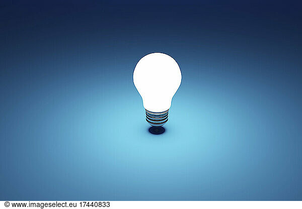 Three dimensional render of single light bulb glowing against blue background